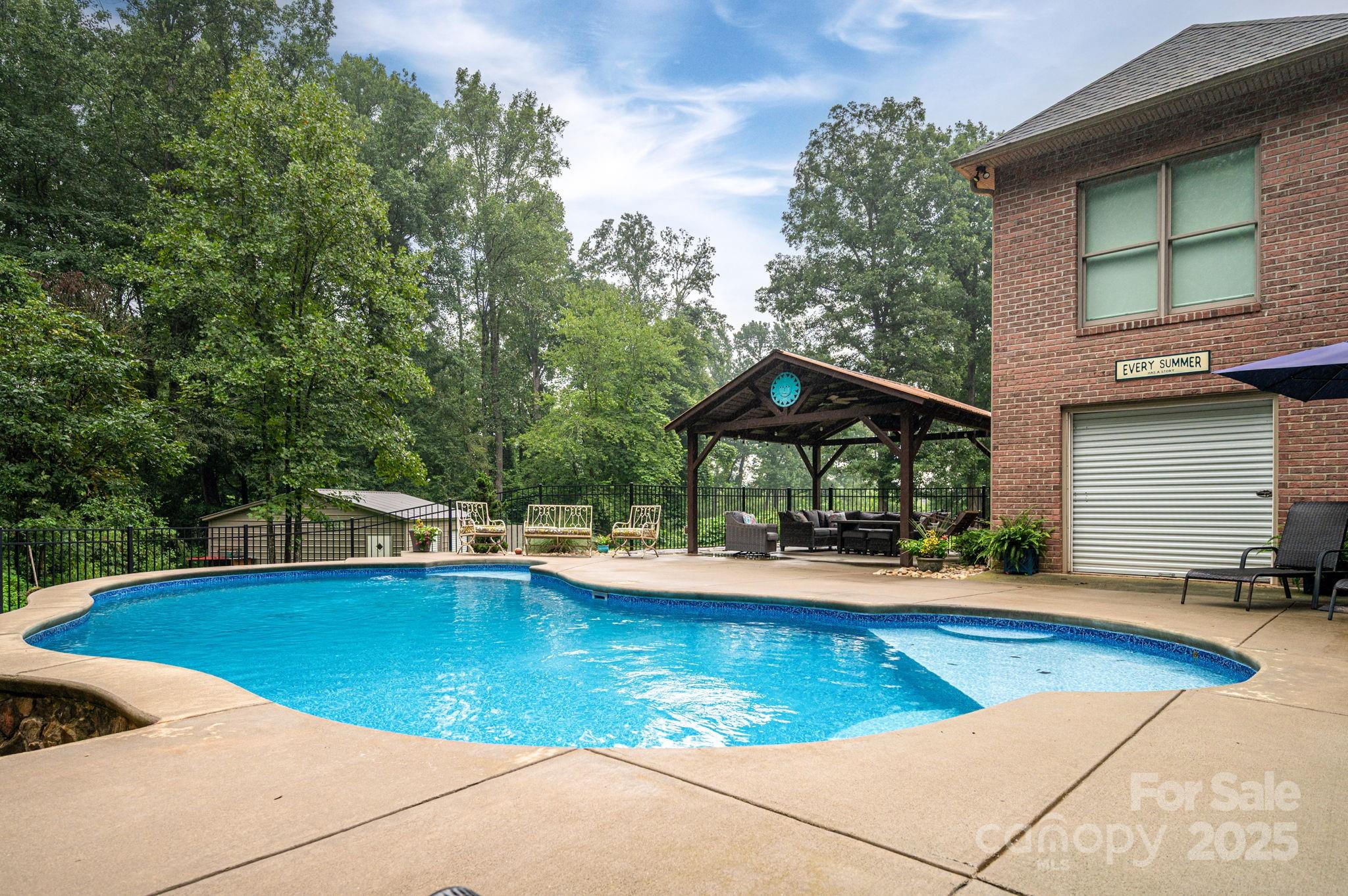 543 Roy Eaker Road Cherryville, NC 28021 - Photo 39 of 43 a view of pool with lawn chairs under an umbrella
