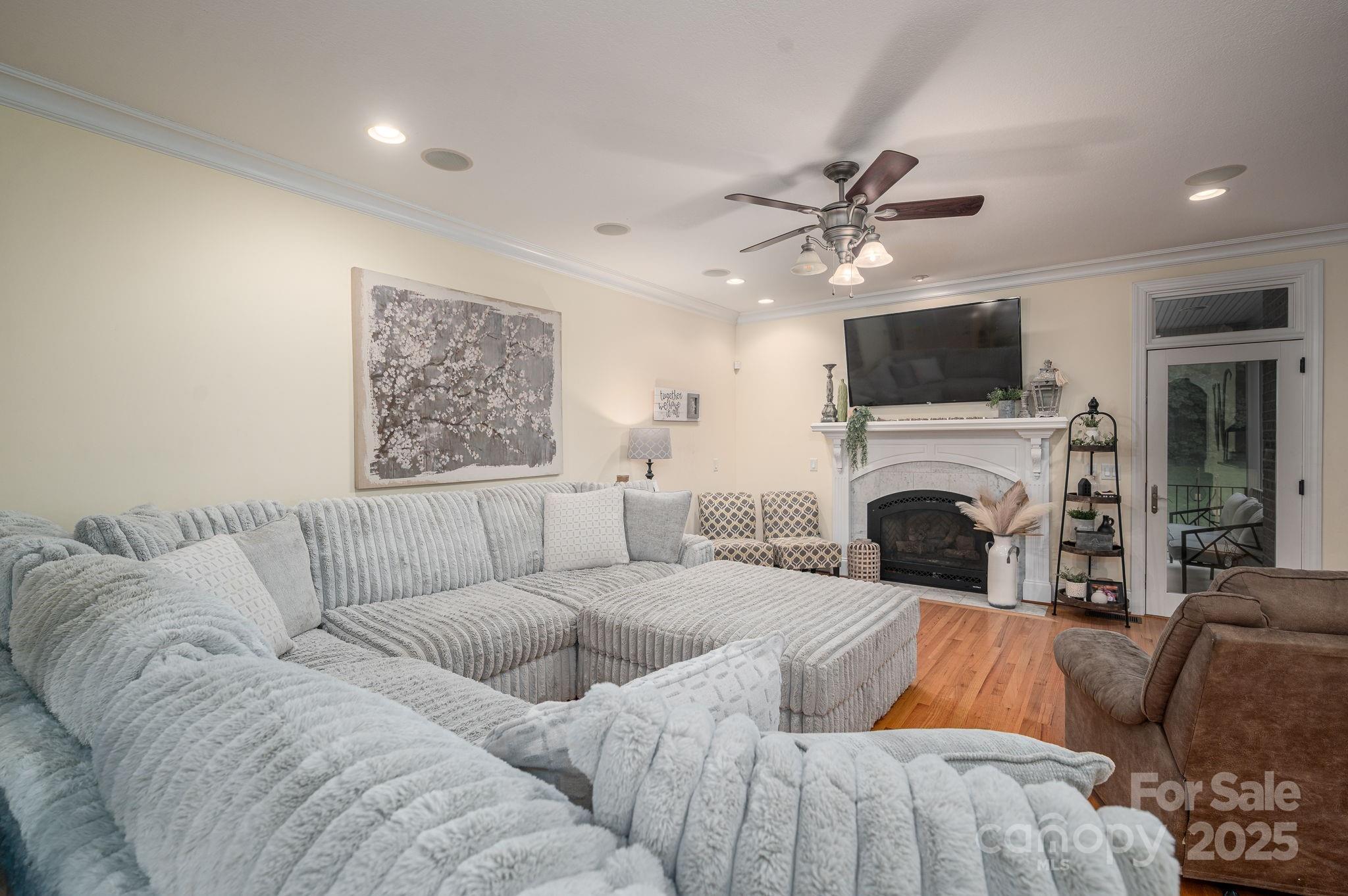 543 Roy Eaker Road Cherryville, NC 28021 - Photo 7 of 43 a living room with furniture a fireplace and a flat screen tv