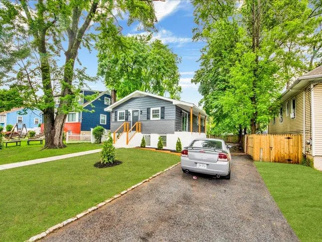 a front view of a house with a garden