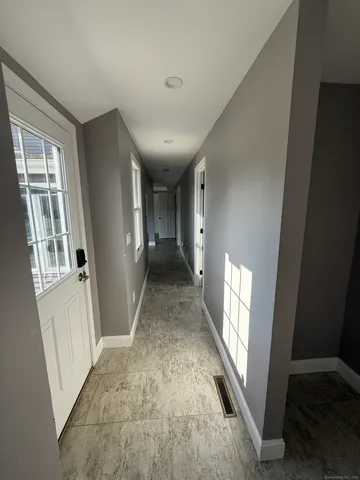a view of hallway with window and stairs
