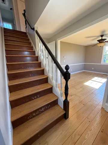 a view of empty room with window and wooden floor