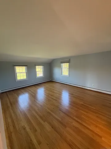 a bathroom with a granite countertop sink toilet and a mirror