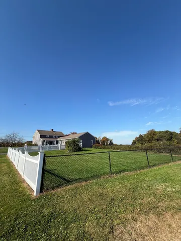 a view of a field with sitting area