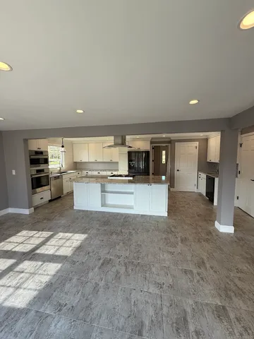 a view of kitchen and refrigerator