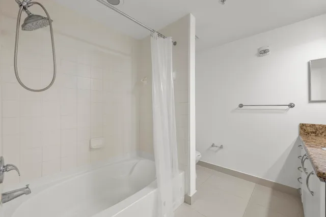 a bathroom with a bath tub with a shower