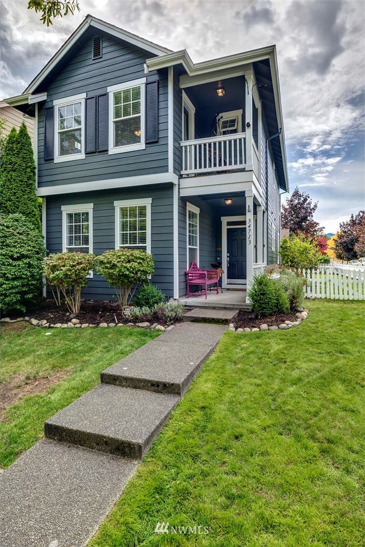 34713 Southeast Ridge Street Snoqualmie, WA 98065 - Photo 2 of 22 a front view of a house with a yard and garage