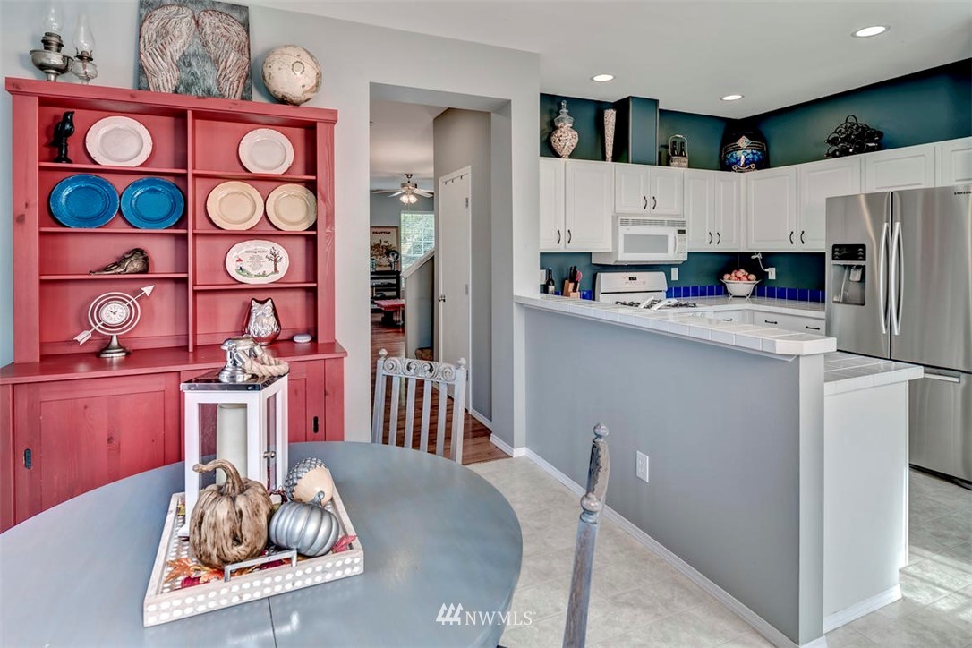 34713 Southeast Ridge Street Snoqualmie, WA 98065 - Photo 12 of 22 a kitchen with stainless steel appliances granite countertop a sink dishwasher a refrigerator and microwave with wooden floor