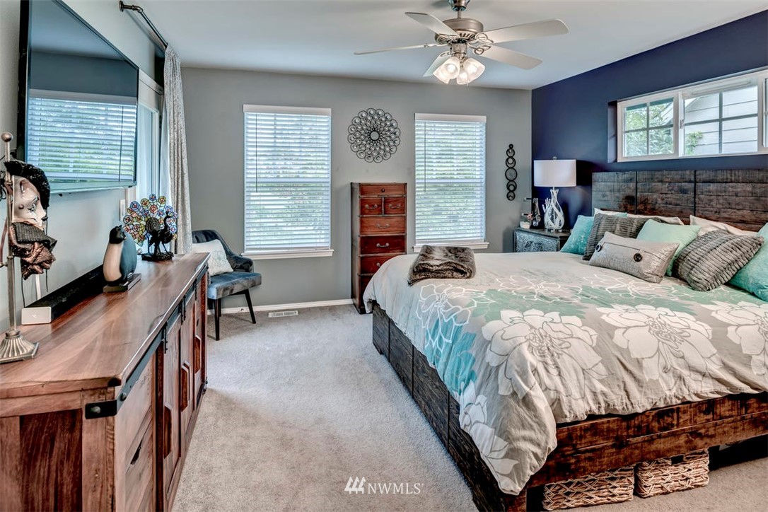 34713 Southeast Ridge Street Snoqualmie, WA 98065 - Photo 15 of 22 a bedroom with a bed and a chandelier