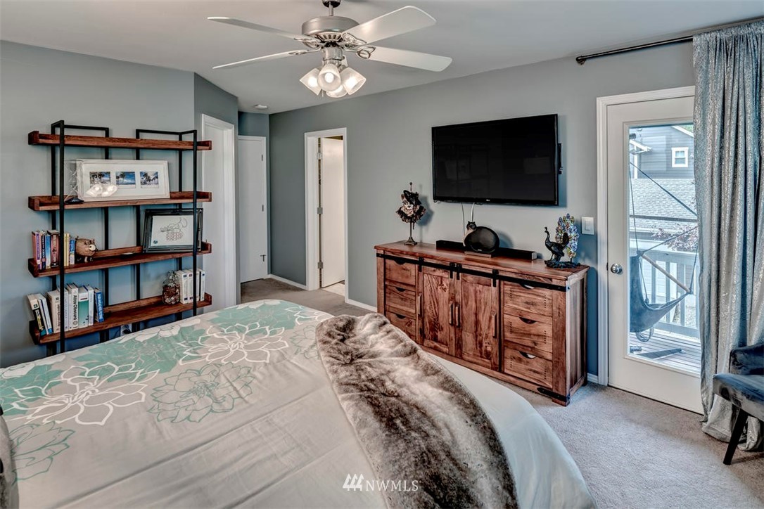 34713 Southeast Ridge Street Snoqualmie, WA 98065 - Photo 16 of 22 a bedroom with a bed furniture and a flat screen tv