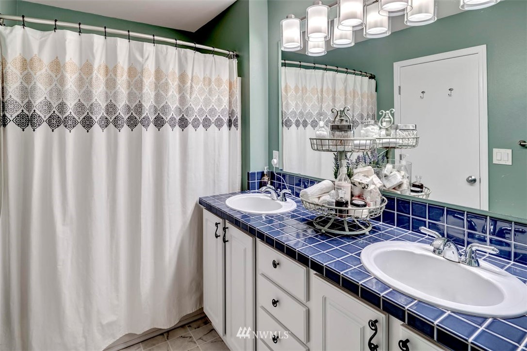 34713 Southeast Ridge Street Snoqualmie, WA 98065 - Photo 17 of 22 a bathroom with a double vanity sink and a mirror