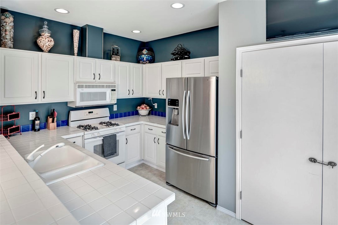 34713 Southeast Ridge Street Snoqualmie, WA 98065 - Photo 6 of 22 a kitchen with stainless steel appliances a refrigerator sink and microwave