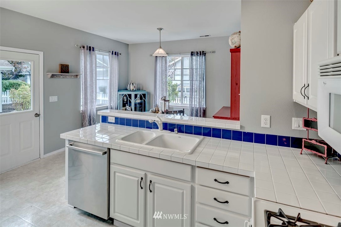 34713 Southeast Ridge Street Snoqualmie, WA 98065 - Photo 8 of 22 a view of a kitchen with a sink and wooden floor