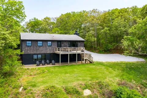 a view of a house with pool and a yard