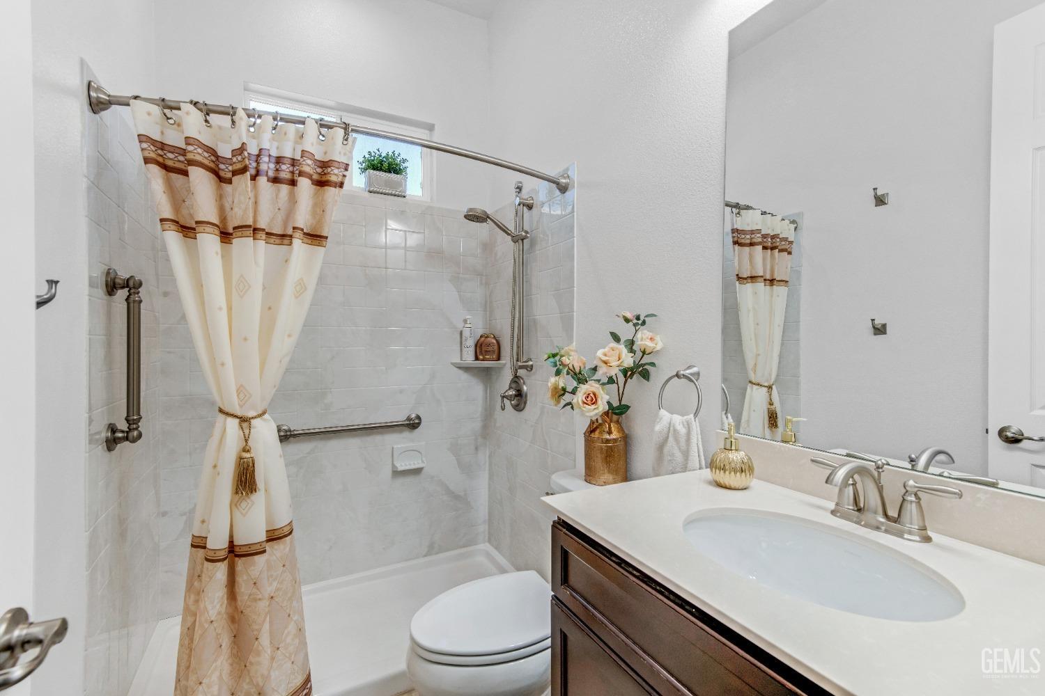 Undisclosed Address Bakersfield, CA 93306 - Photo 12 of 49 a bathroom with a sink toilet and shower