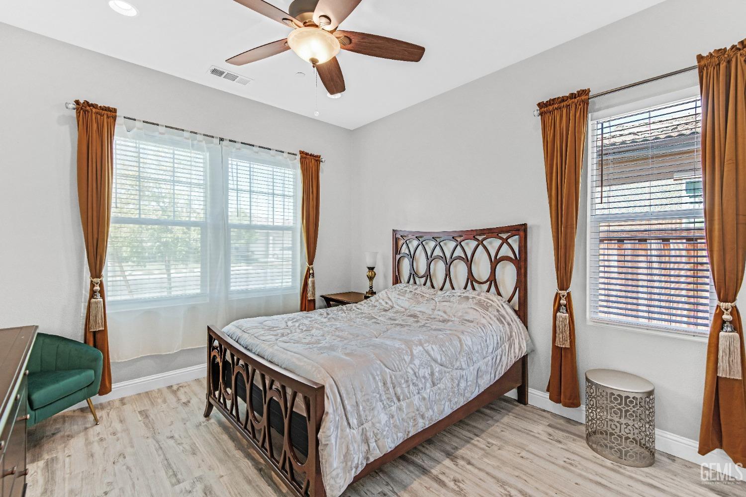 Undisclosed Address Bakersfield, CA 93306 - Photo 13 of 49 a bedroom with a bed and a chandelier