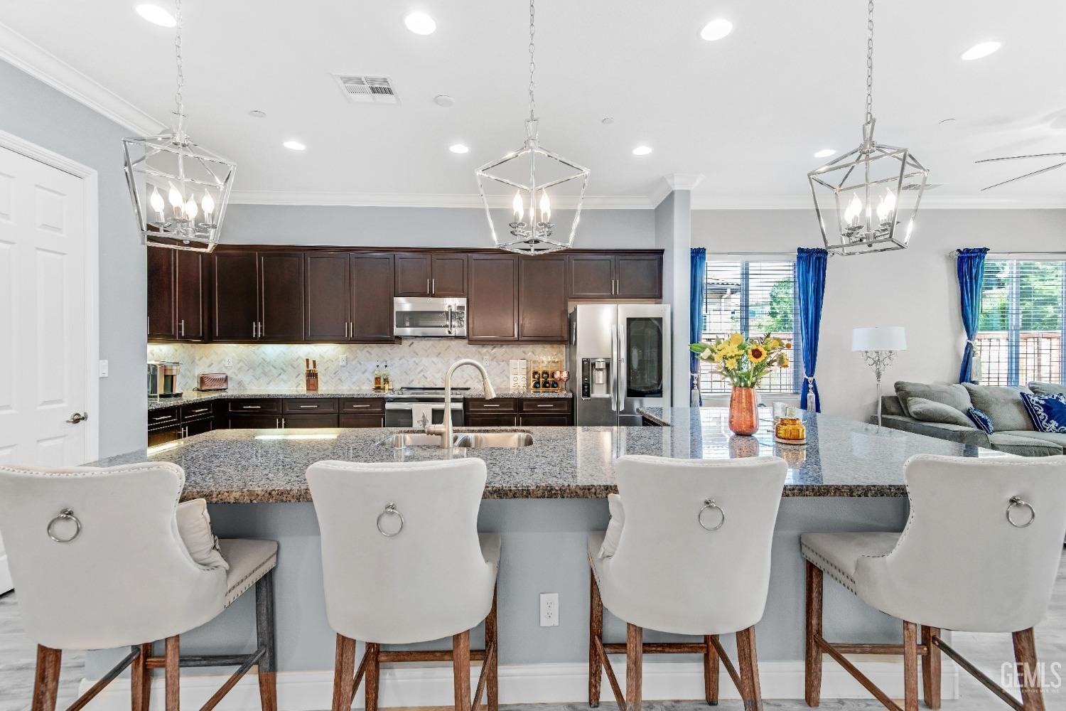 Undisclosed Address Bakersfield, CA 93306 - Photo 2 of 49 a kitchen with stainless steel appliances granite countertop a dining table chairs refrigerator and microwave