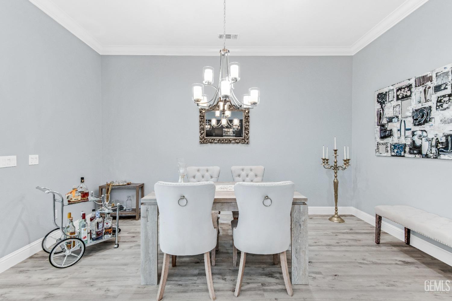 Undisclosed Address Bakersfield, CA 93306 - Photo 21 of 49 a view of a dining room with furniture wooden floor and a chandelier
