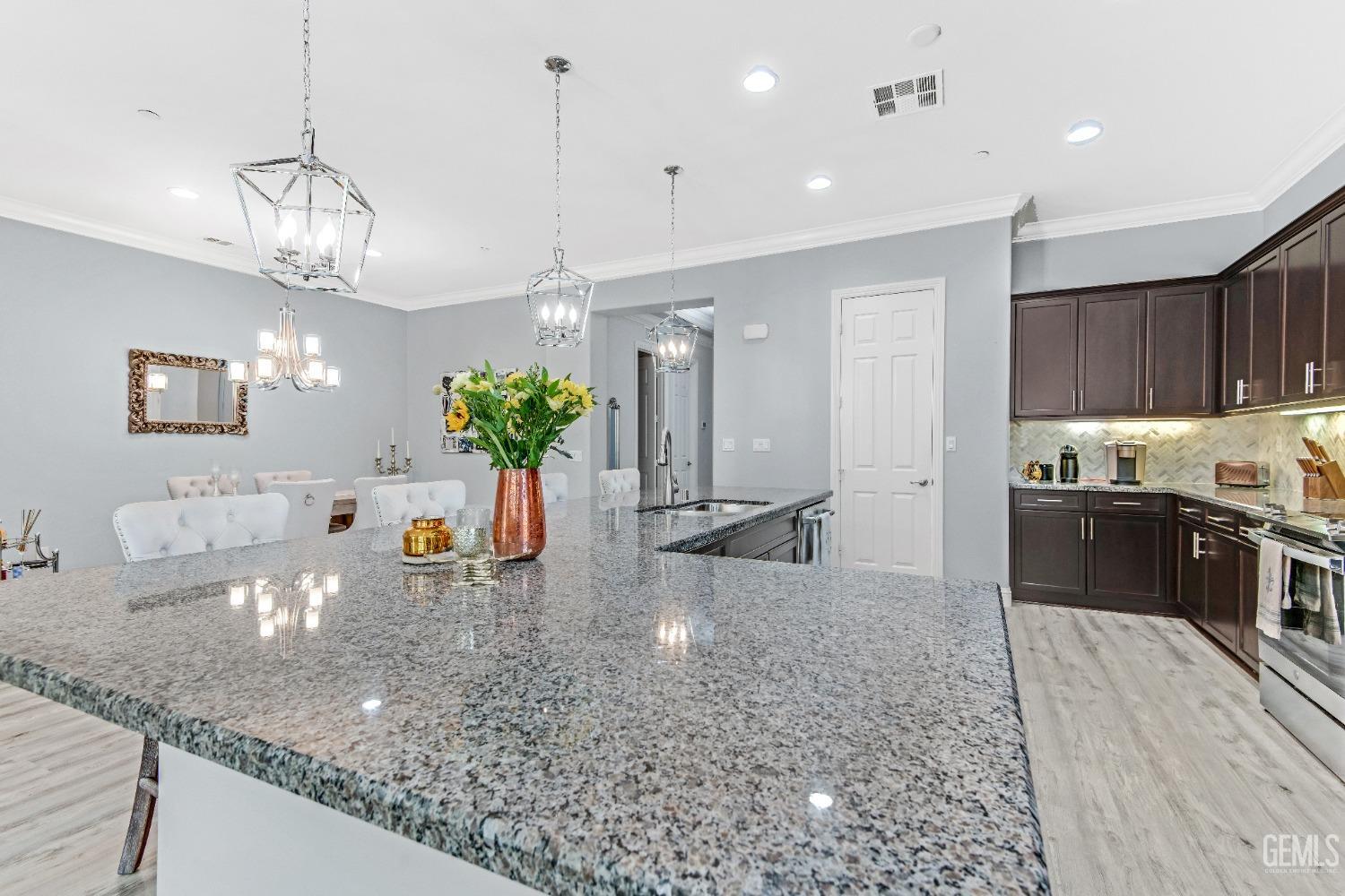 Undisclosed Address Bakersfield, CA 93306 - Photo 25 of 49 a large kitchen with granite countertop a large counter top and stainless steel appliances
