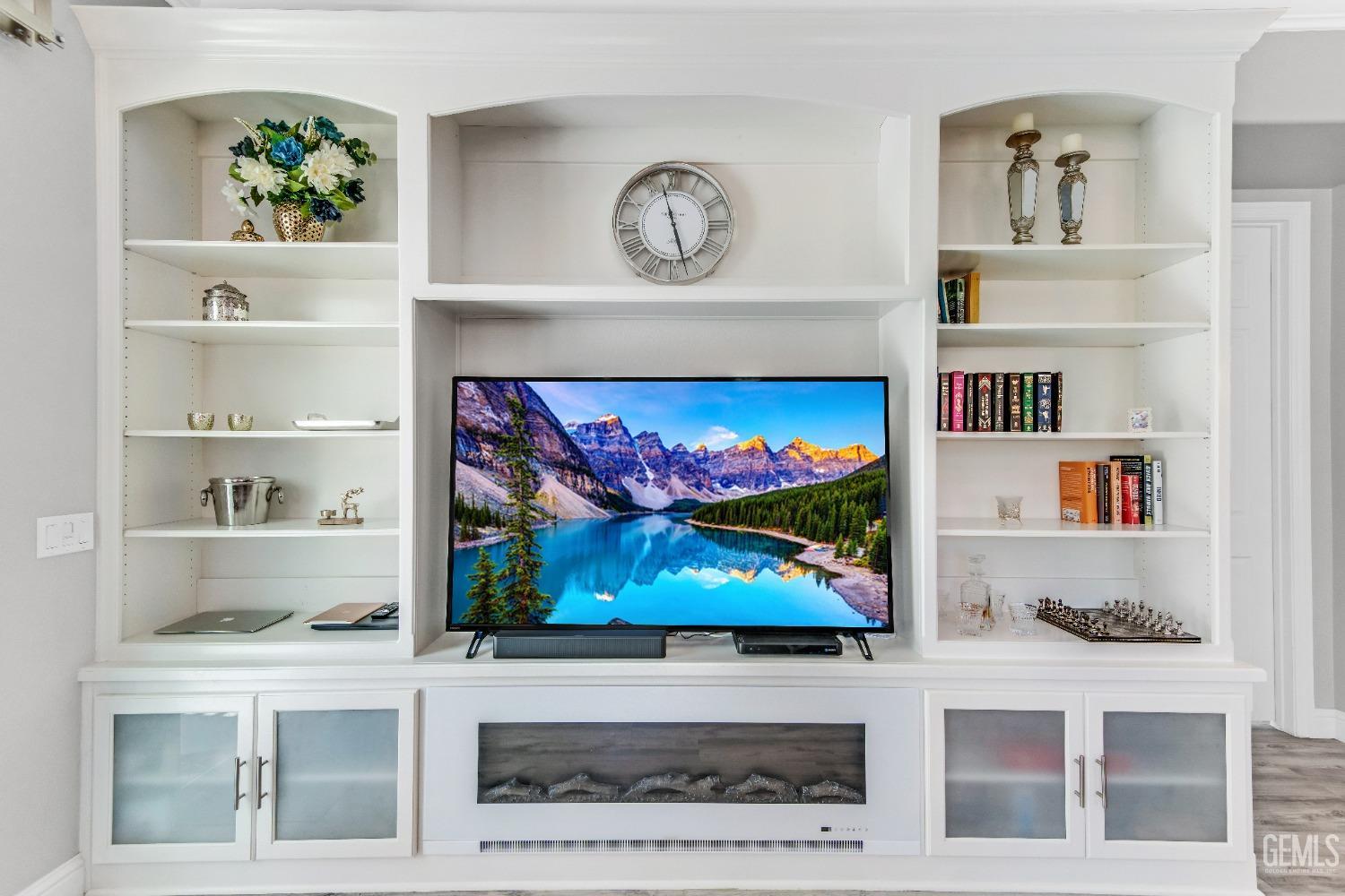 Undisclosed Address Bakersfield, CA 93306 - Photo 32 of 49 a living room with lots of painting and a painting on the wall