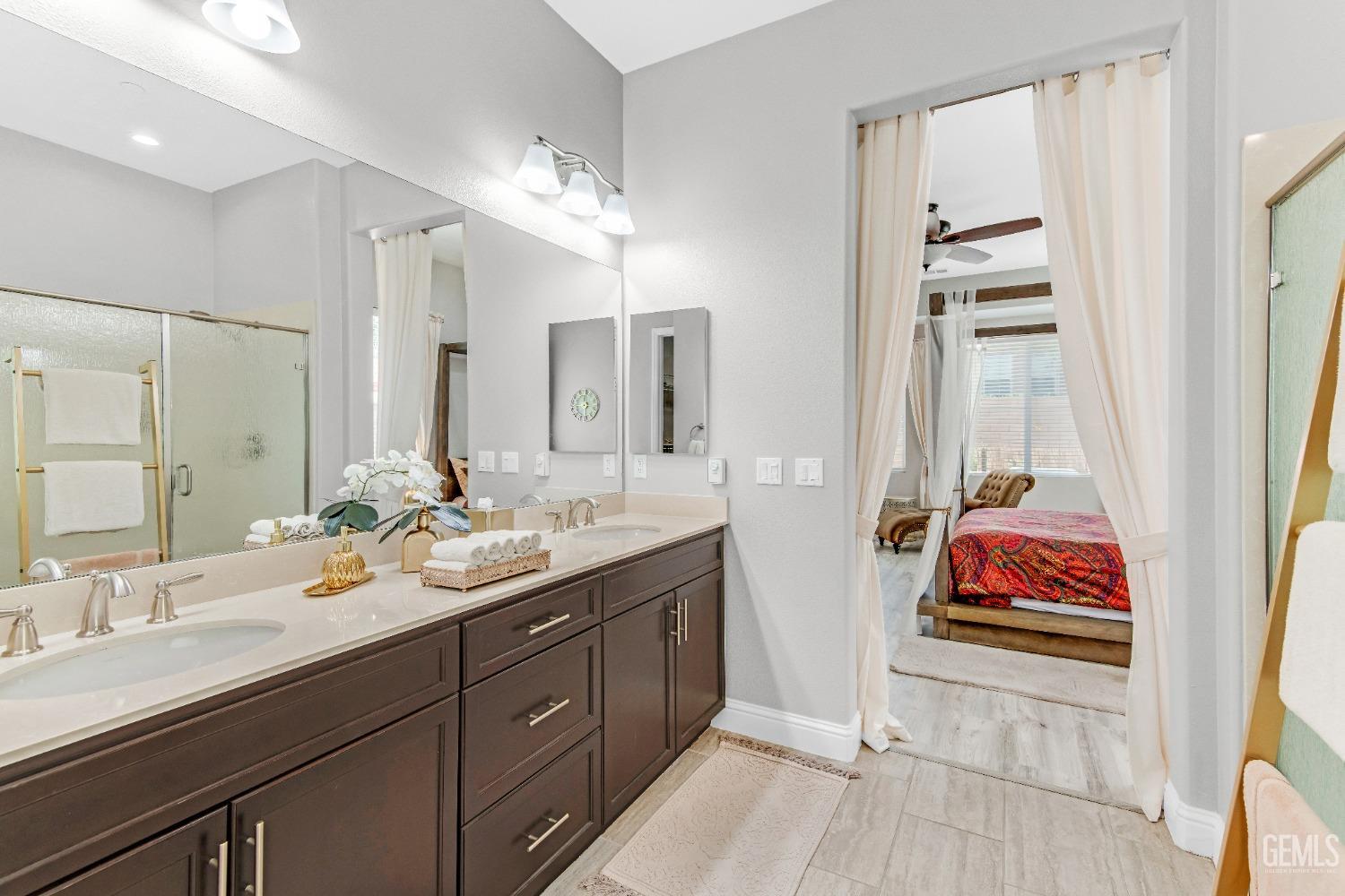 Undisclosed Address Bakersfield, CA 93306 - Photo 38 of 49 a en suite bathroom with double vanity and a mirror