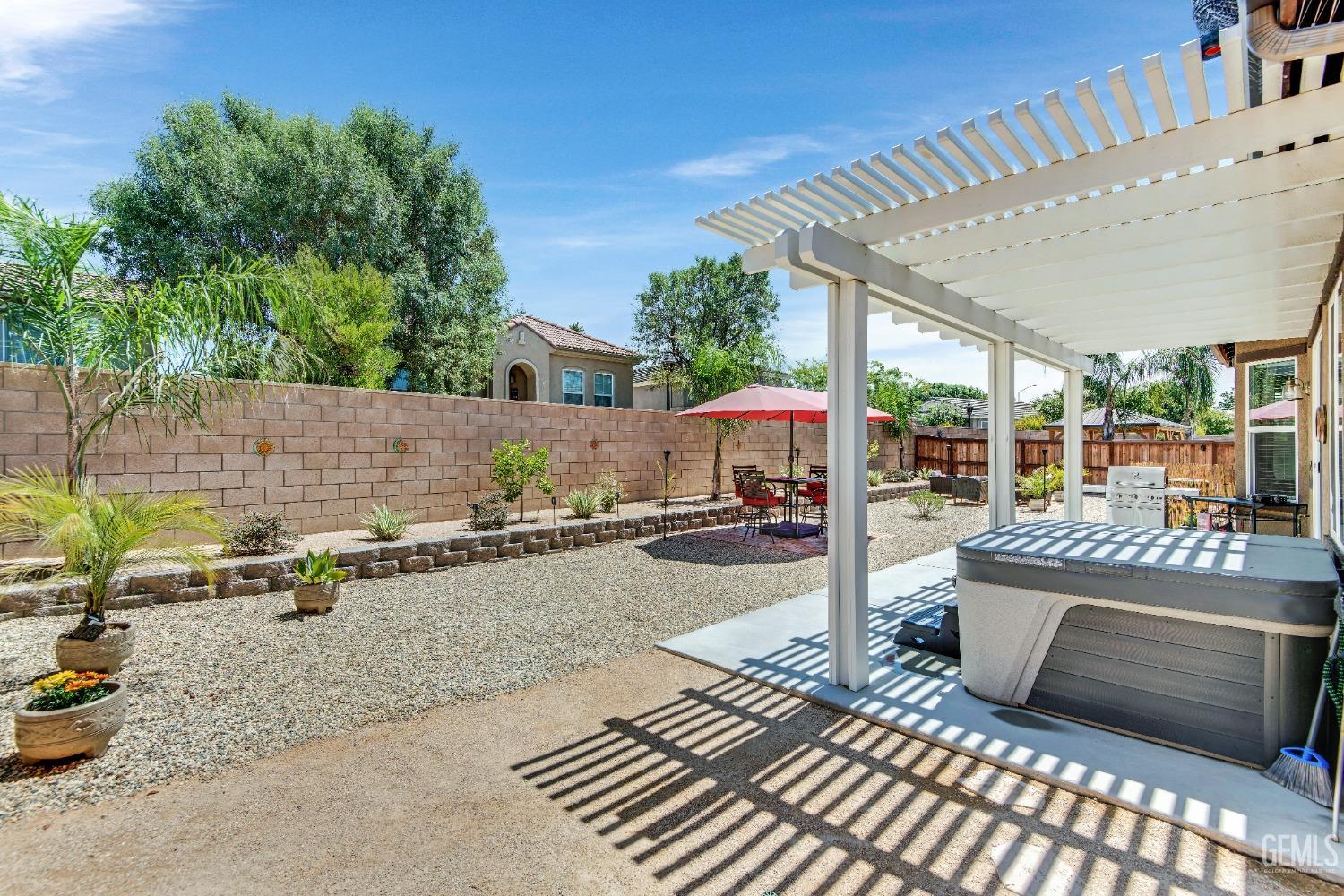 Undisclosed Address Bakersfield, CA 93306 - Photo 39 of 49 a view of a patio with table and chairs barbeque potted plants and large tree