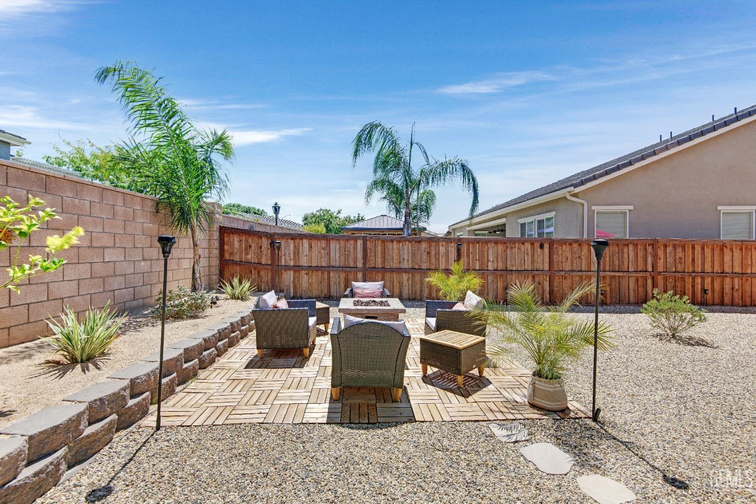 Undisclosed Address Bakersfield, CA 93306 - Photo 43 of 49 a view of a patio with couches potted plants and wooden fence