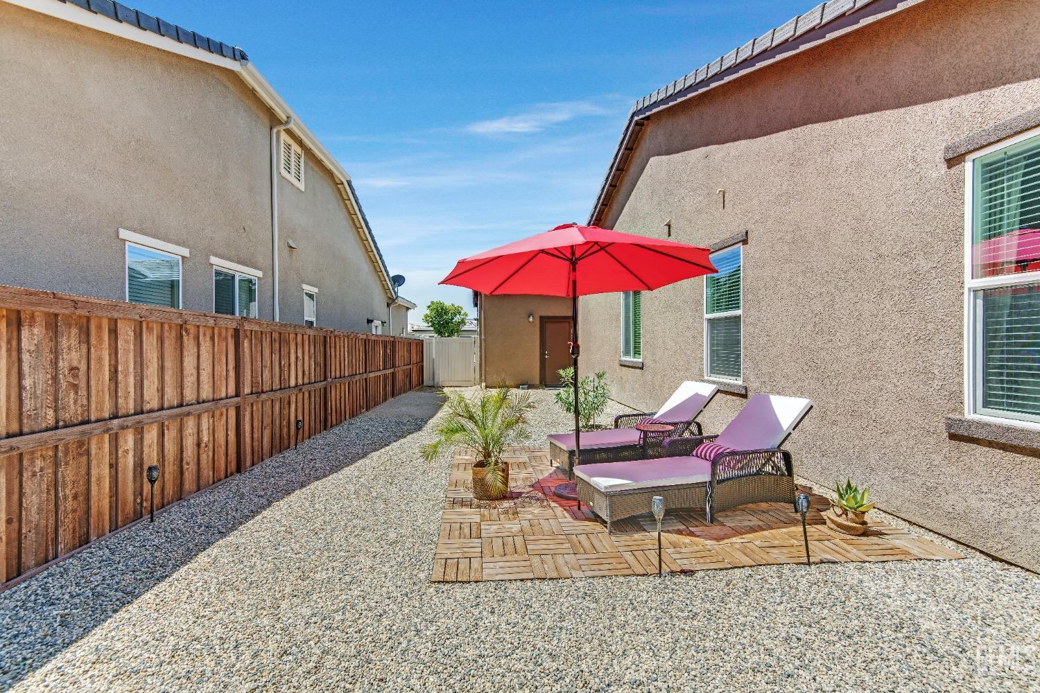 Undisclosed Address Bakersfield, CA 93306 - Photo 44 of 49 a view of a chairs and table under an umbrella in patio