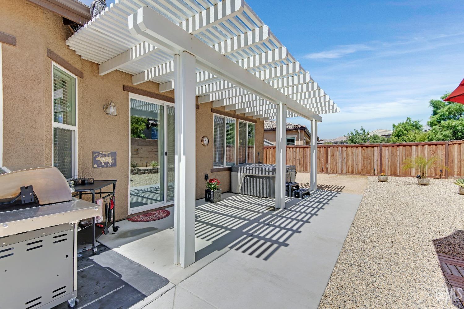 Undisclosed Address Bakersfield, CA 93306 - Photo 48 of 49 a view of a house with wooden deck and furniture