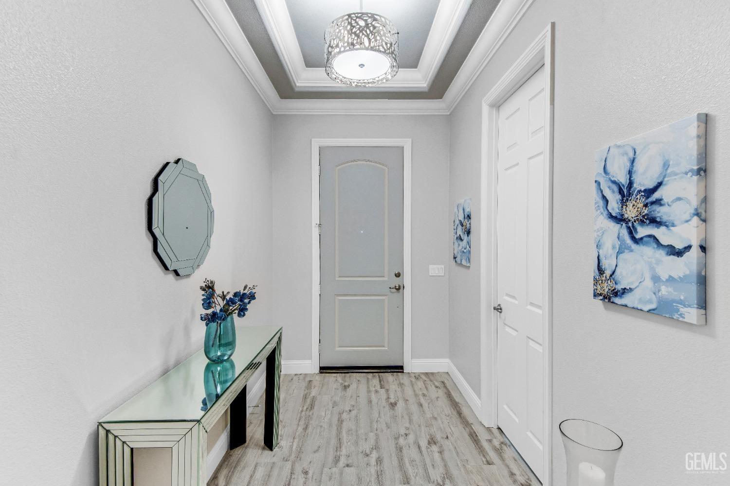 Undisclosed Address Bakersfield, CA 93306 - Photo 9 of 49 a view of a hallway with wooden floor and a potted plant