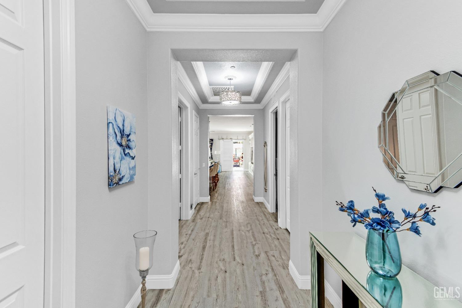 Undisclosed Address Bakersfield, CA 93306 - Photo 10 of 49 a view of a hallway with wooden floor and a chandelier