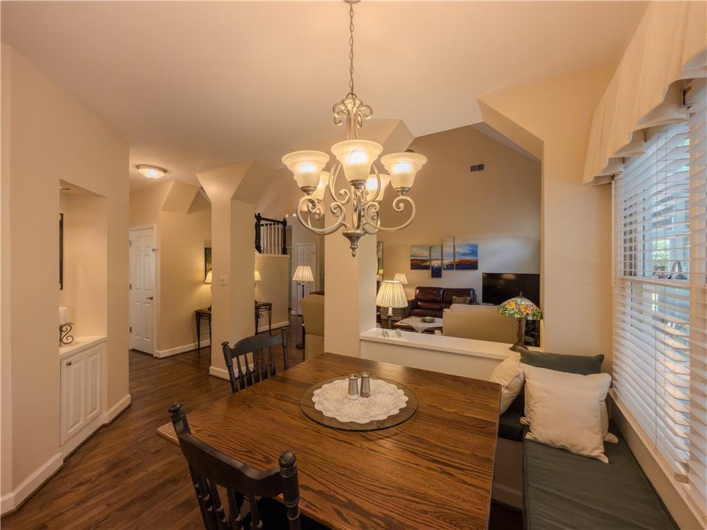 4284 Cedar Bluff Way Southwest Lilburn, GA 30047 - Photo 23 of 62 a view of a dining room with furniture and wooden floor