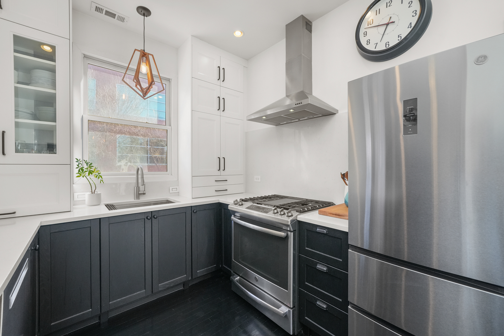 1735 West Division Street, Unit 204 Chicago, IL 60622 - Photo 3 of 26 a kitchen with stainless steel appliances granite countertop a sink a stove a refrigerator a clock and a window
