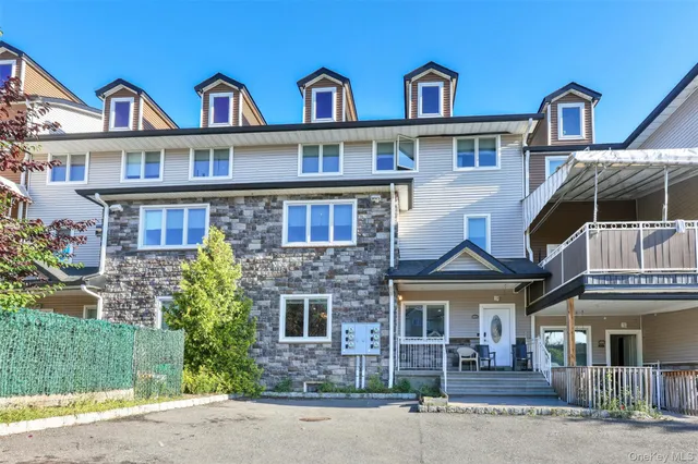 a front view of residential houses with yard