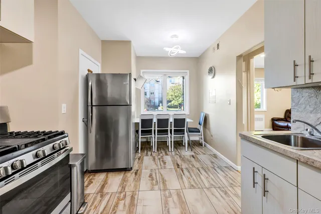 a kitchen with granite countertop a refrigerator and a sink