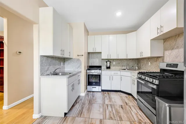 a kitchen with granite countertop cabinets stainless steel appliances and a counter space