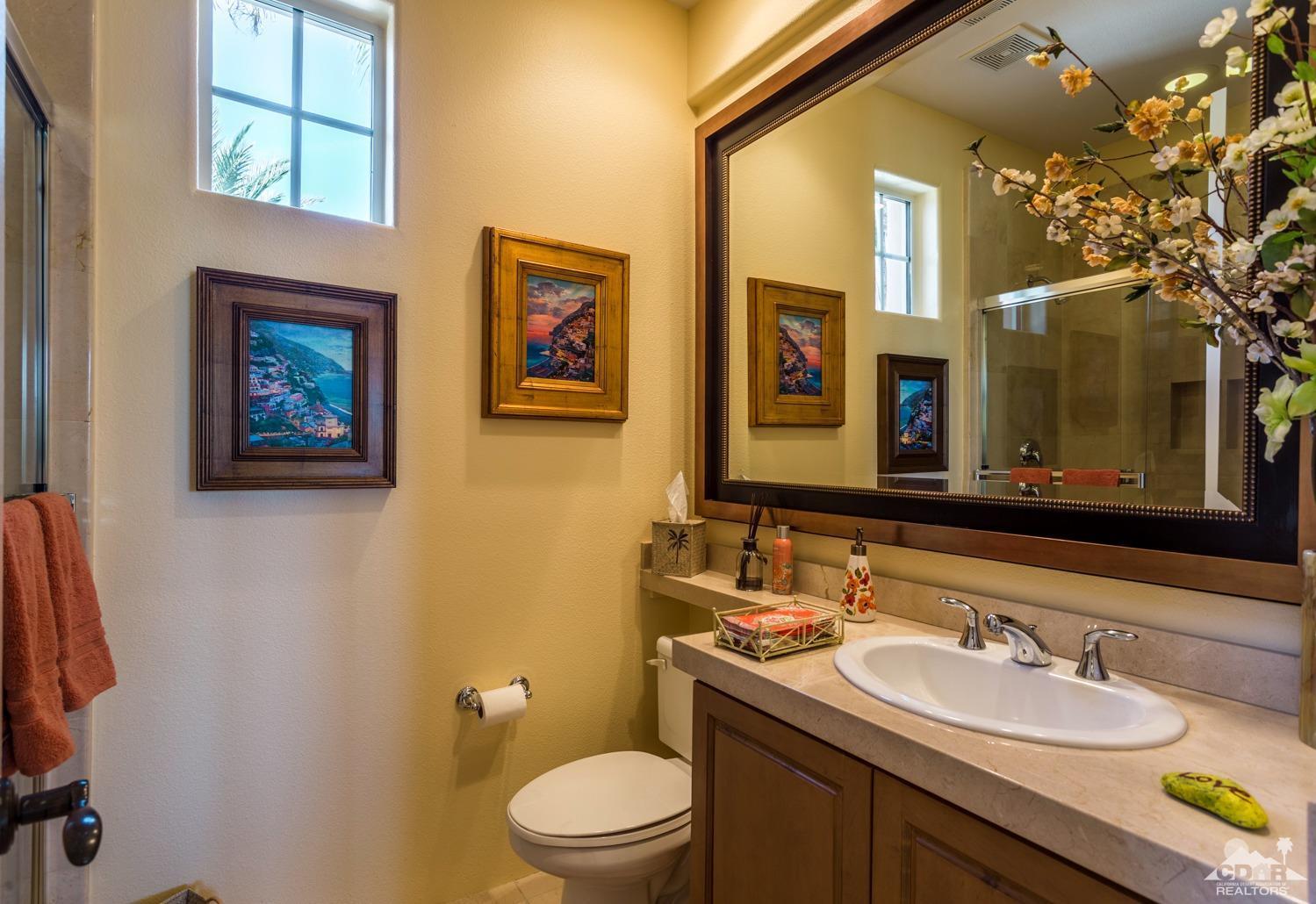 314 Loch Lomond Road Rancho Mirage, CA 92270 - Photo 16 of 48 a bathroom with a toilet a sink and mirror