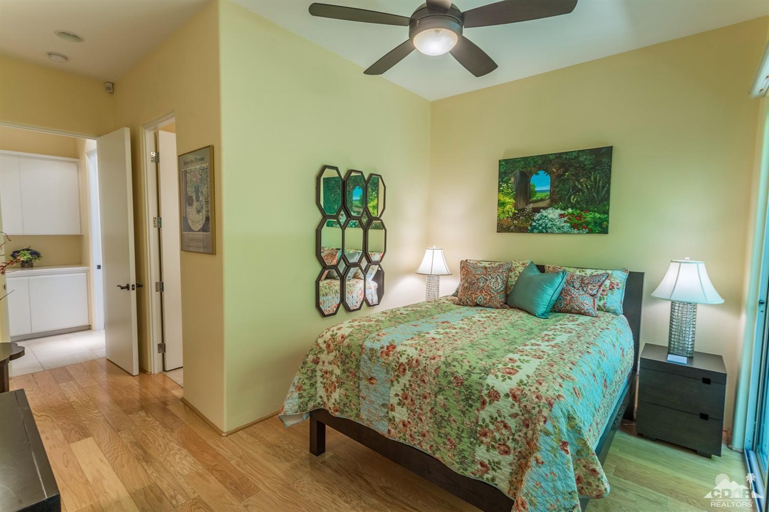 314 Loch Lomond Road Rancho Mirage, CA 92270 - Photo 18 of 48 a bedroom with a bed and a chandelier