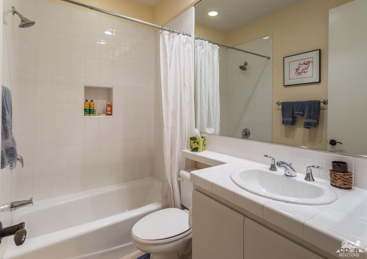 314 Loch Lomond Road Rancho Mirage, CA 92270 - Photo 19 of 48 a bathroom with a granite countertop sink toilet and shower
