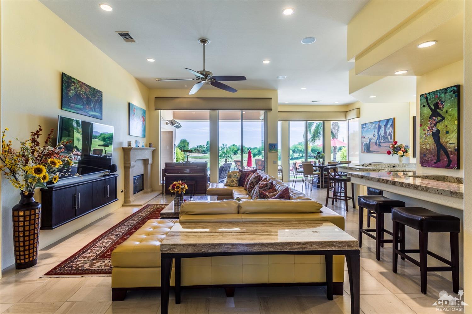 314 Loch Lomond Road Rancho Mirage, CA 92270 - Photo 21 of 48 a view of a dining room with furniture a rug and a chandelier
