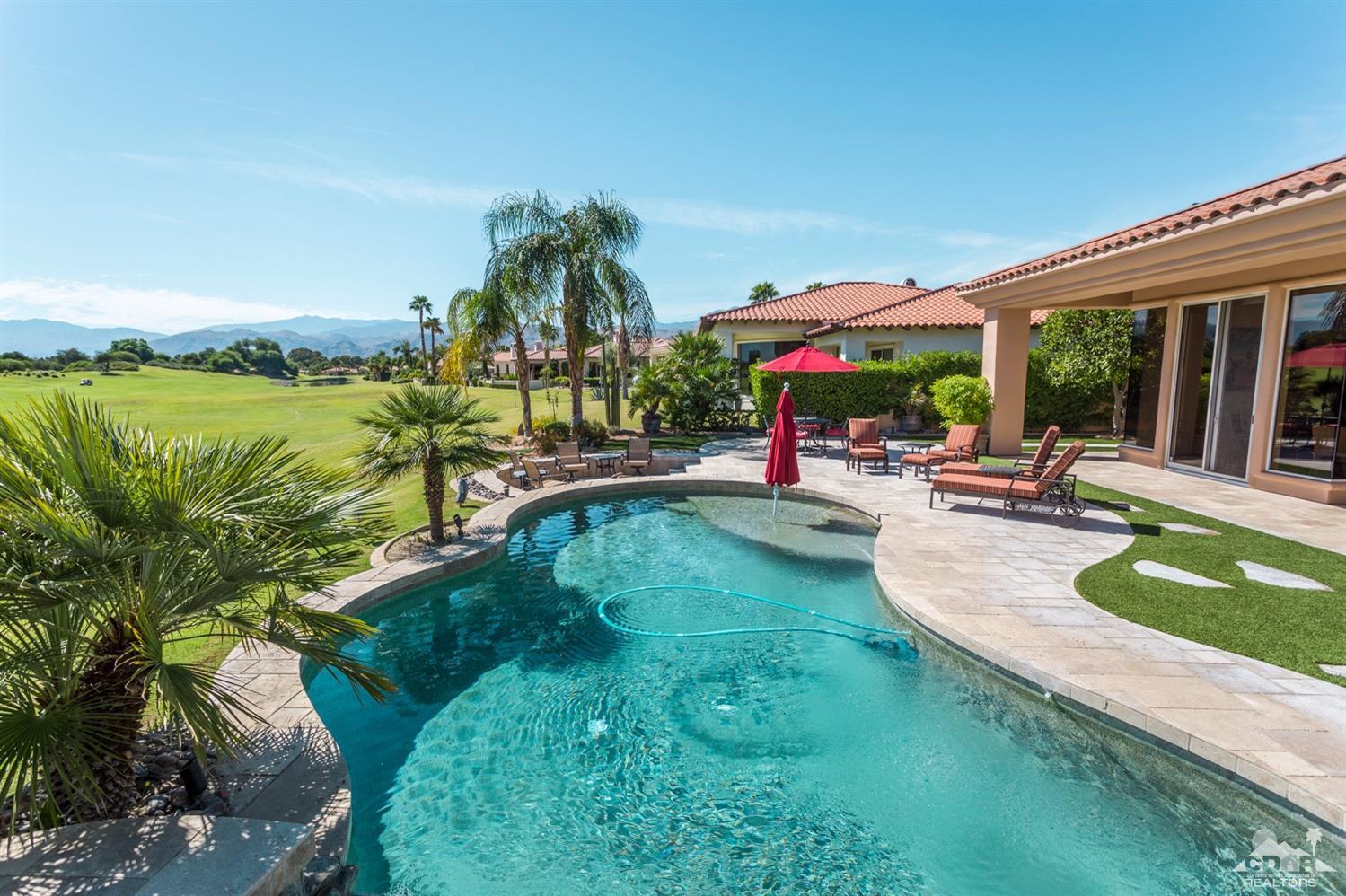 314 Loch Lomond Road Rancho Mirage, CA 92270 - Photo 3 of 48 a view of a swimming pool with lawn chairs and plants