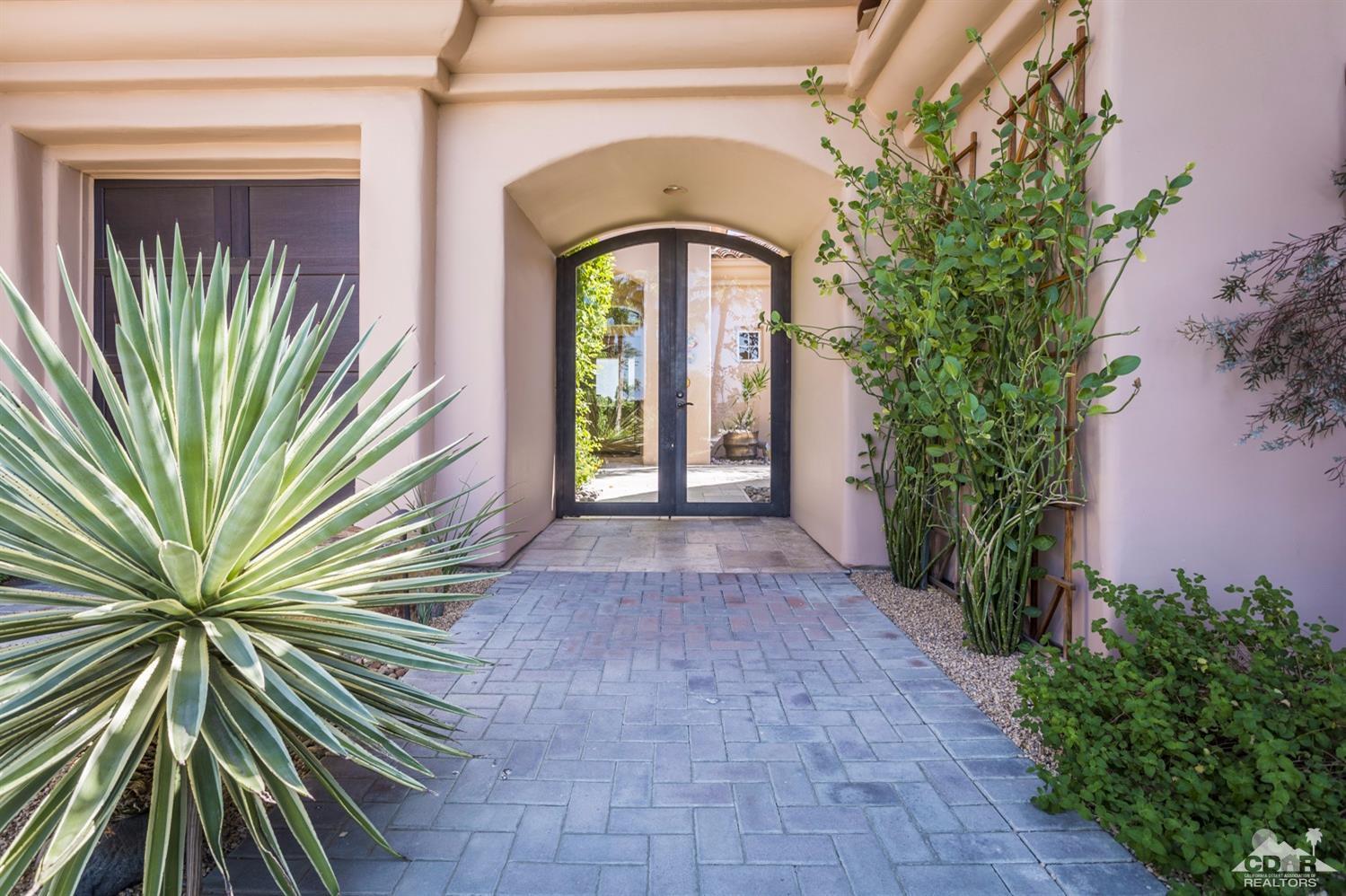 314 Loch Lomond Road Rancho Mirage, CA 92270 - Photo 36 of 48 a front view of a house with a garden
