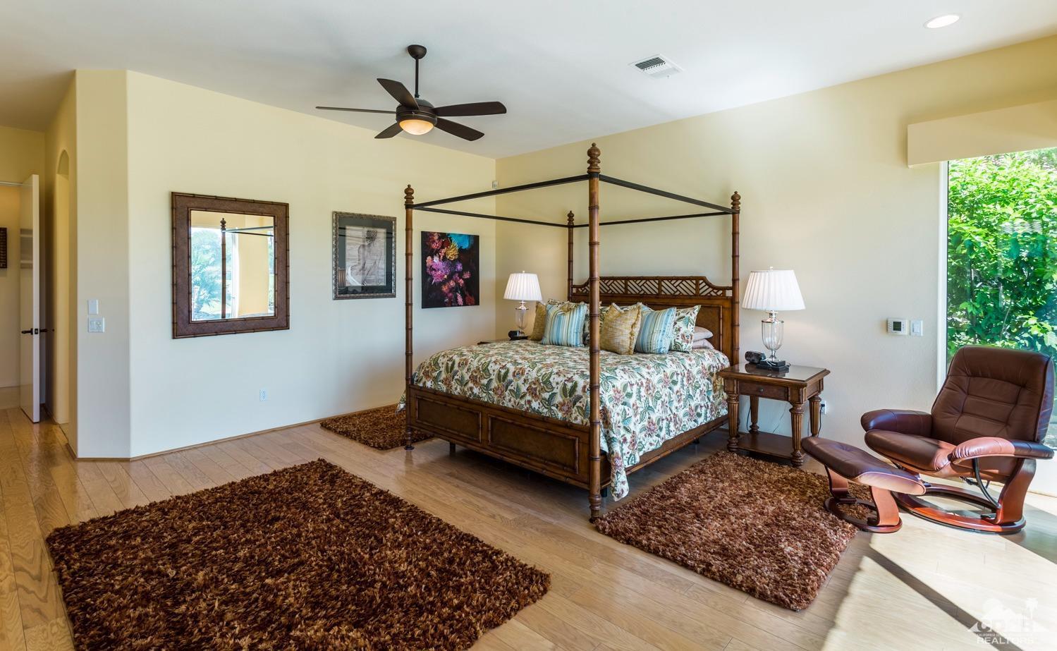 314 Loch Lomond Road Rancho Mirage, CA 92270 - Photo 7 of 48 a bedroom with a bed a couch and a window