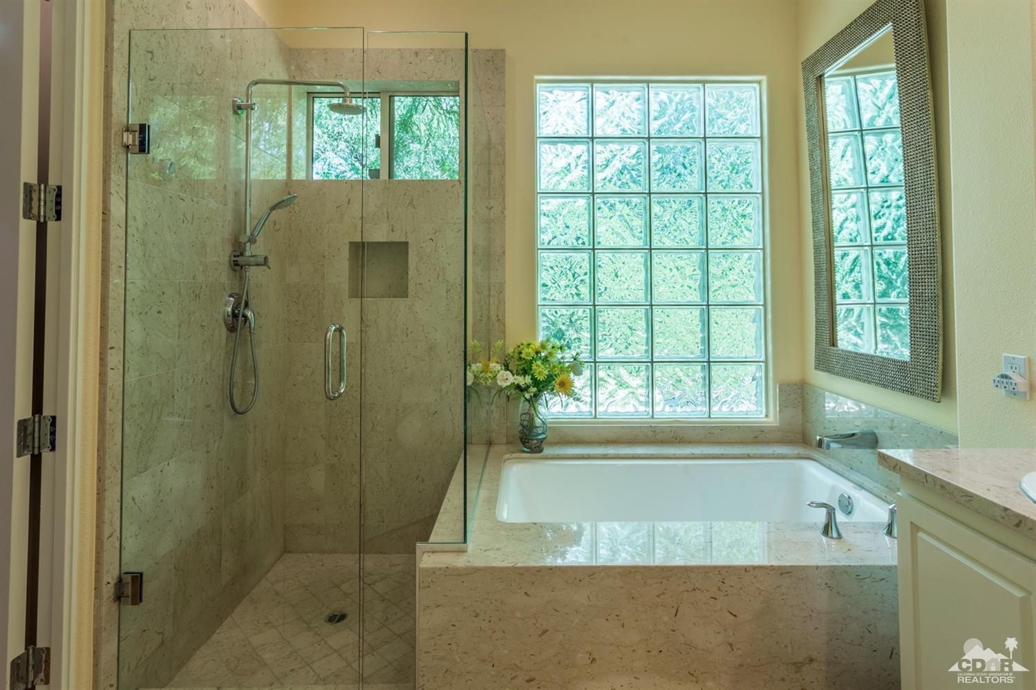 314 Loch Lomond Road Rancho Mirage, CA 92270 - Photo 8 of 48 a bathroom with a granite countertop tub shower and sink