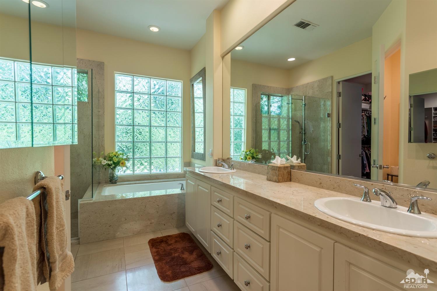 314 Loch Lomond Road Rancho Mirage, CA 92270 - Photo 9 of 48 a spacious bathroom with double vanity and a large mirror