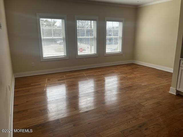 2419 Bridge Avenue, Unit 203 Point Pleasant, NJ 08742 - Photo 8 of 8 an empty room with wooden floor and windows