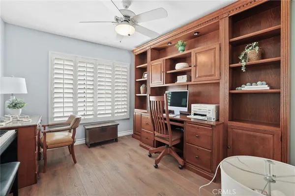 a view of a workspace with furniture and a window
