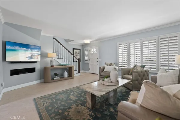 a living room with furniture a flat screen tv and a fireplace