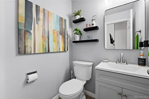 a bathroom with a toilet a sink and a mirror