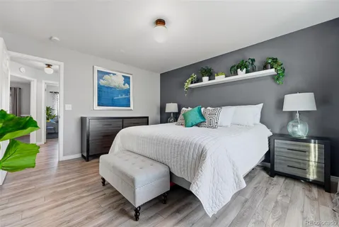 a bedroom with bed and wooden floor