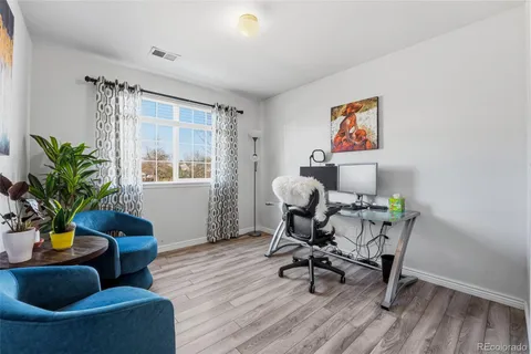 a workspace with furniture and a potted plant